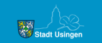 Logo der Stadt Usingen: Links ist das Stadtwappen zu sehen, rechts davon als Strichzeinung ein Kirchturm und ein Kleeblatt. Unten drunter steht als Schriftzug Stadt Usingen.
