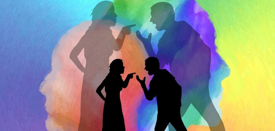 Ein Mann und eine Frau, welche sich streiten. Im Hintergrund sind sehr viele Farben, es sieht aus wie ein Regenbogen. Die Farben sollen die Gefühle der Personen widerspiegeln, deswegen sind verschiedene Farbverläufe zu erkennen.